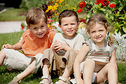 A group of children sitting outside together.