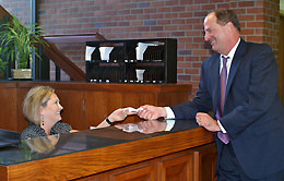 Michael R. Norton at front desk with Susan Bartman